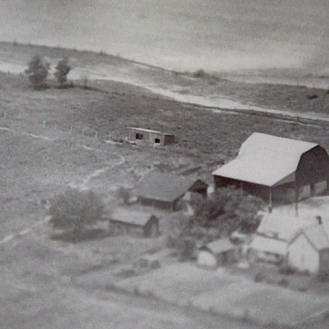 A farmhouse in an old black and white photo