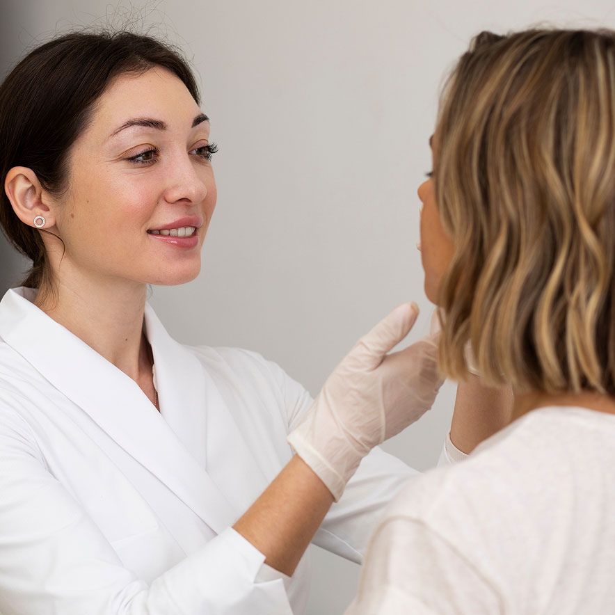A doctor examines her patient's face