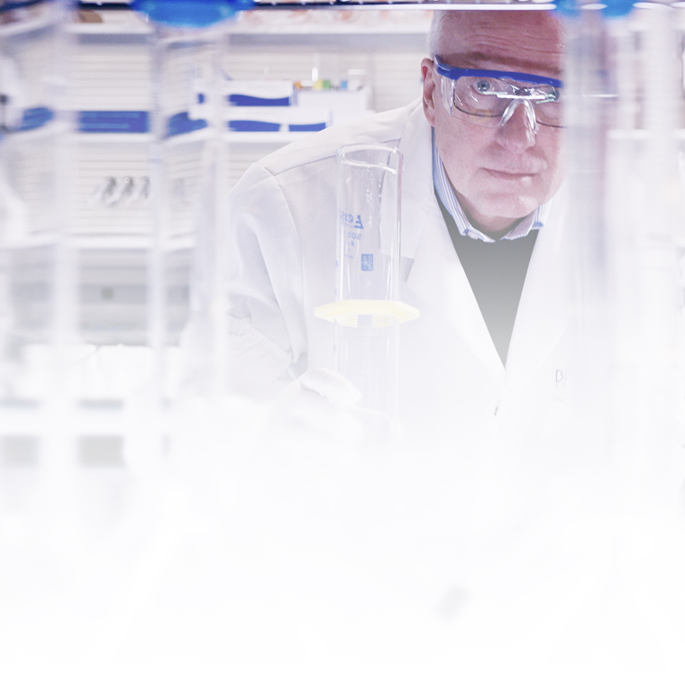 Dr. Lynch working in a laboratory with a variety of beakers and flasks